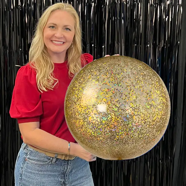 Girl holding a 17&rdquo; glitter reusable balloon