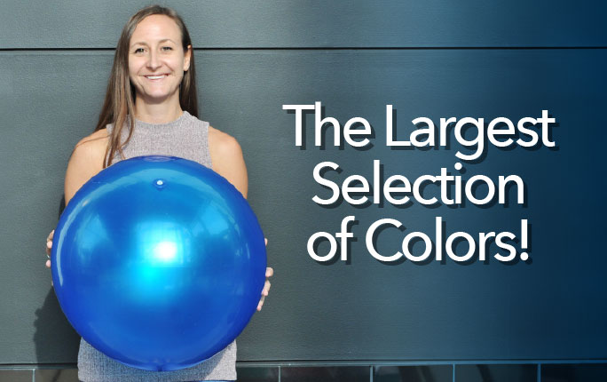 Woman holding a blue reusable balloon. Shop the Largest Selection of Colors for Vinyl Balloons!